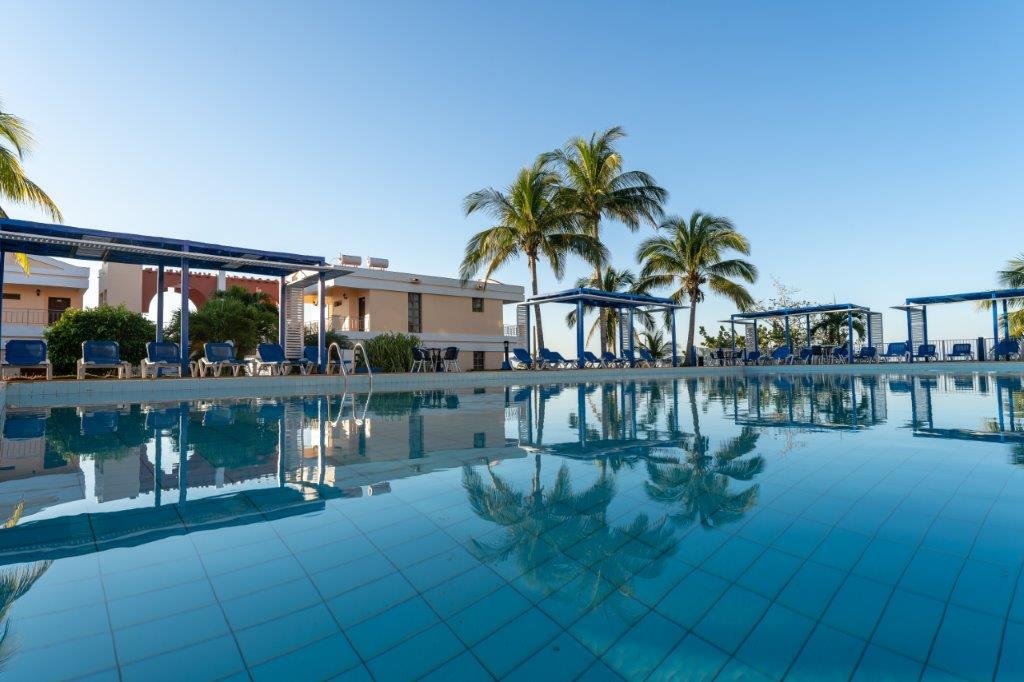 Faro Luna resort pool with palm trees, Cienfuegos